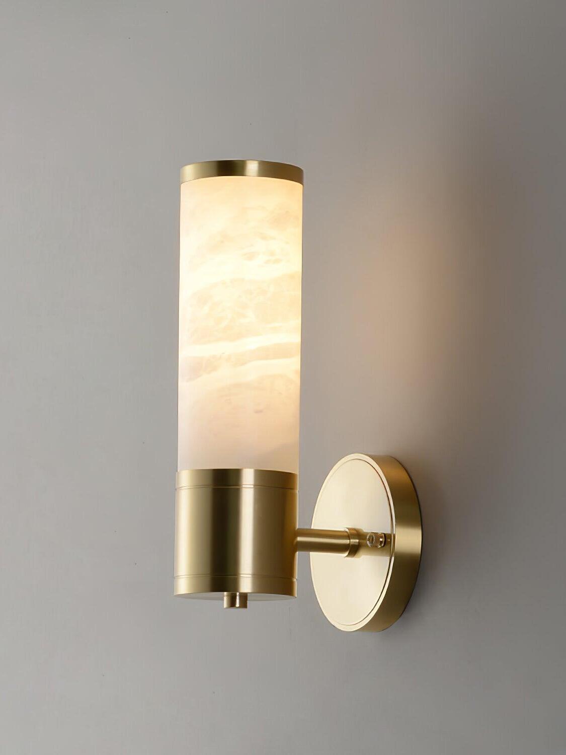 Short glowing white stone cylinder on brass wall plate