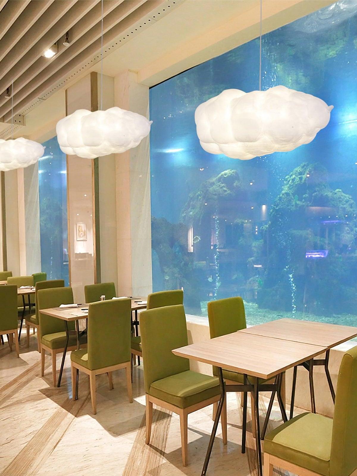 Cloud lights above cafe-style tables and green chairs
