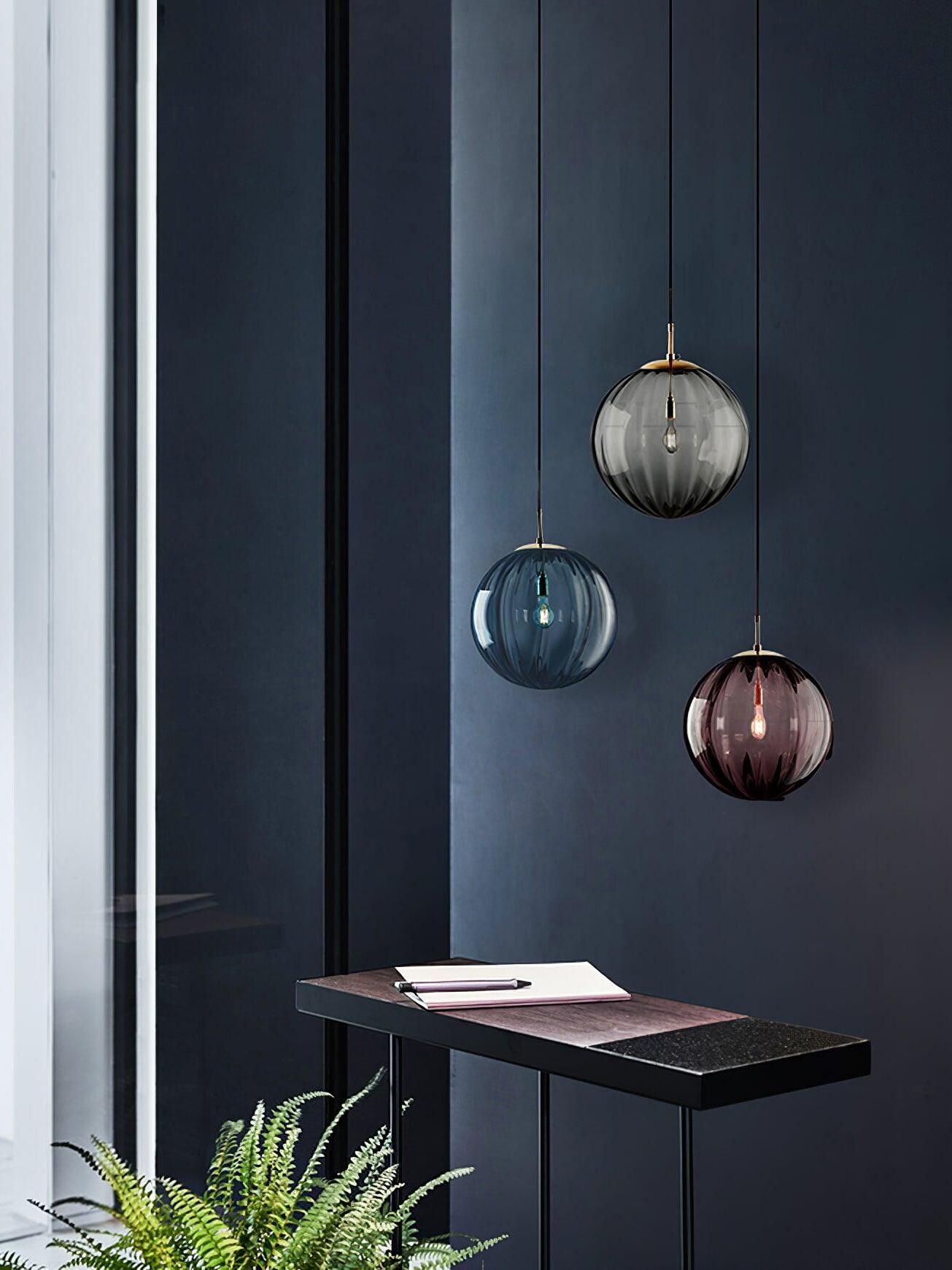 Three fluted glass pendants at staggered heights