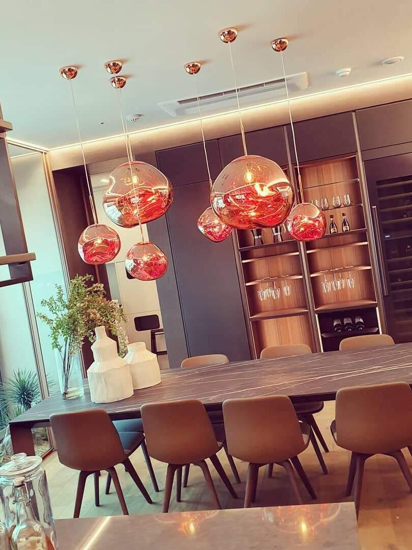 Reflective rounded pendants in a bright dining room