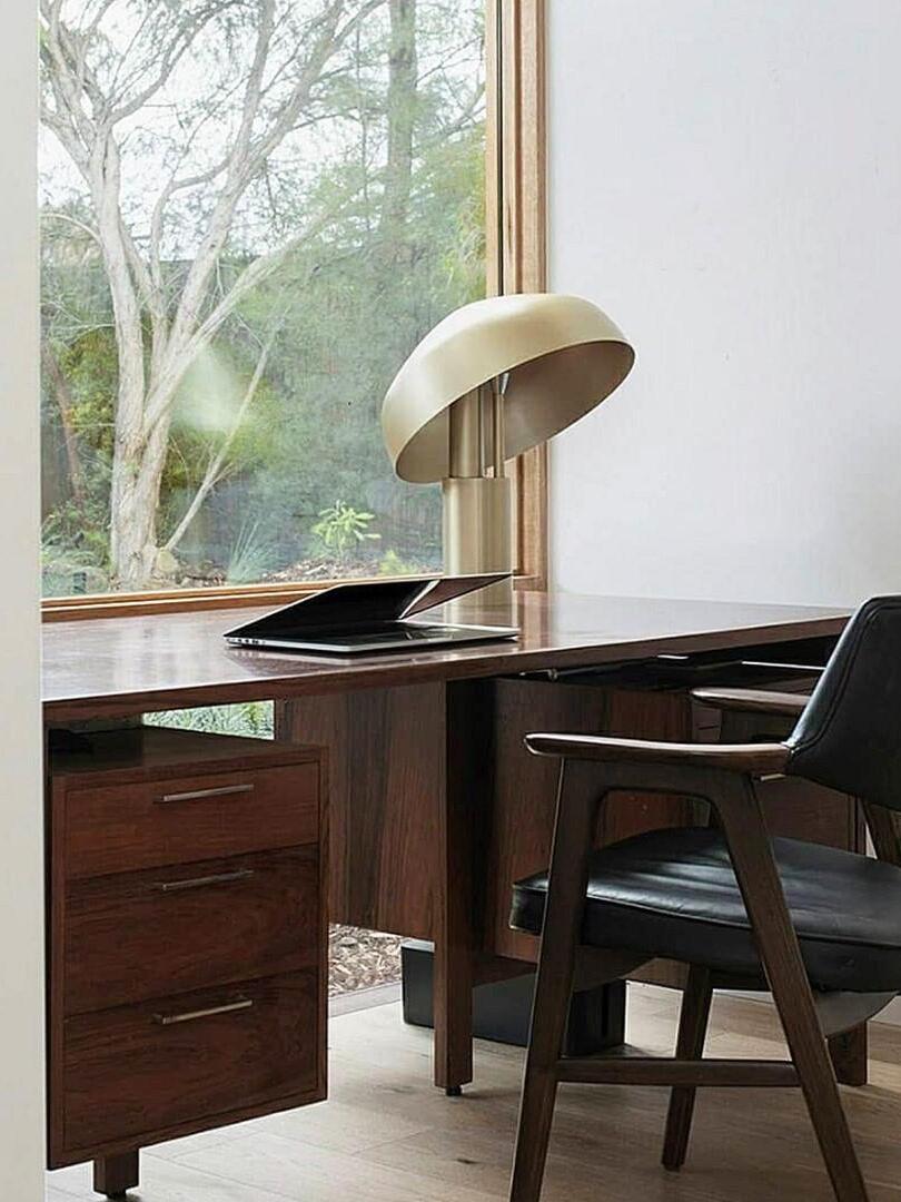 Gold dome table lamp on wooden desk