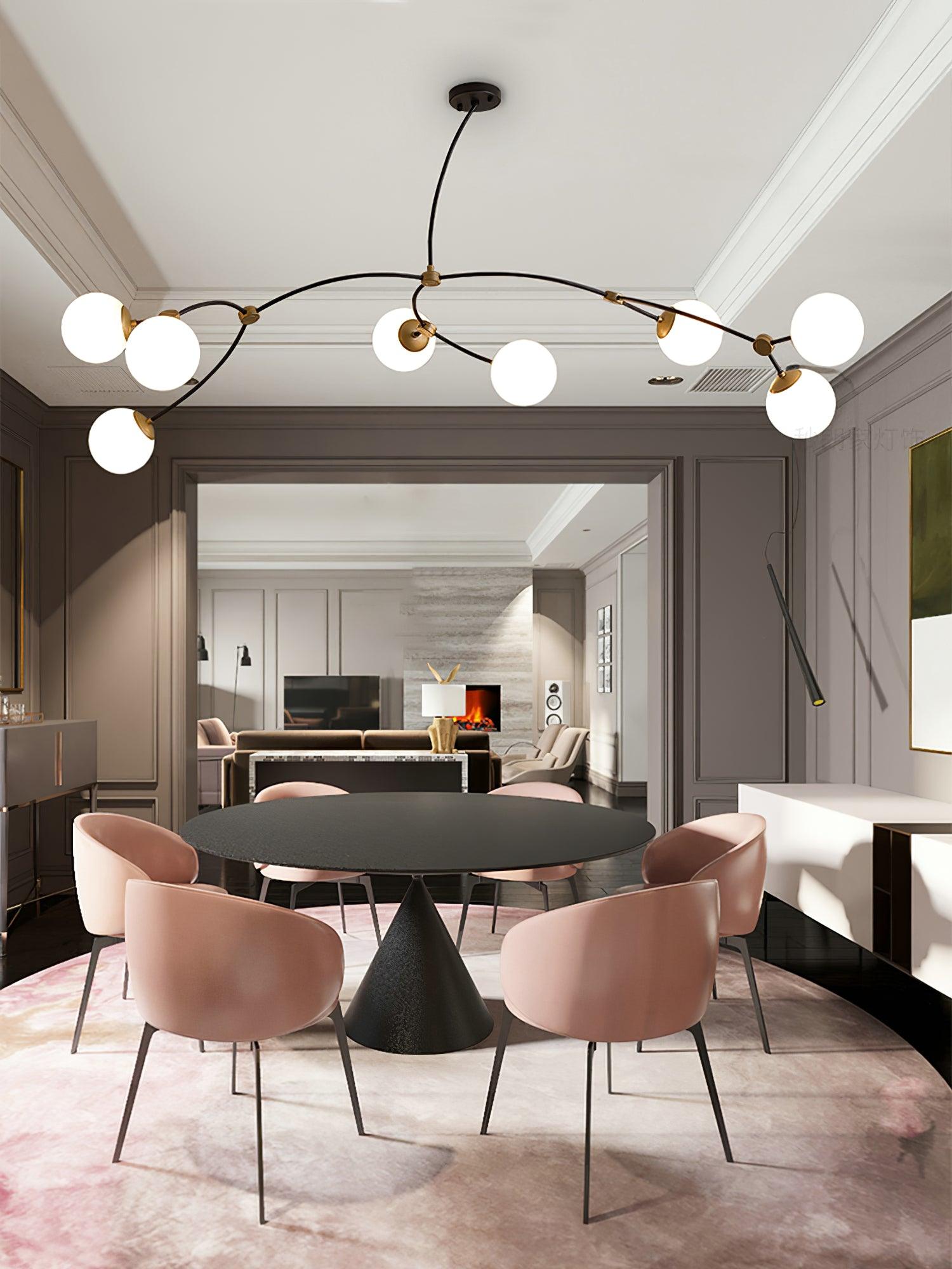 Wide white-globe chandelier above a dining table