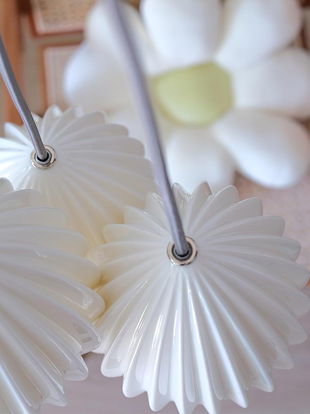 Top view of white ribbed ceramic shades showing their cord entry fittings