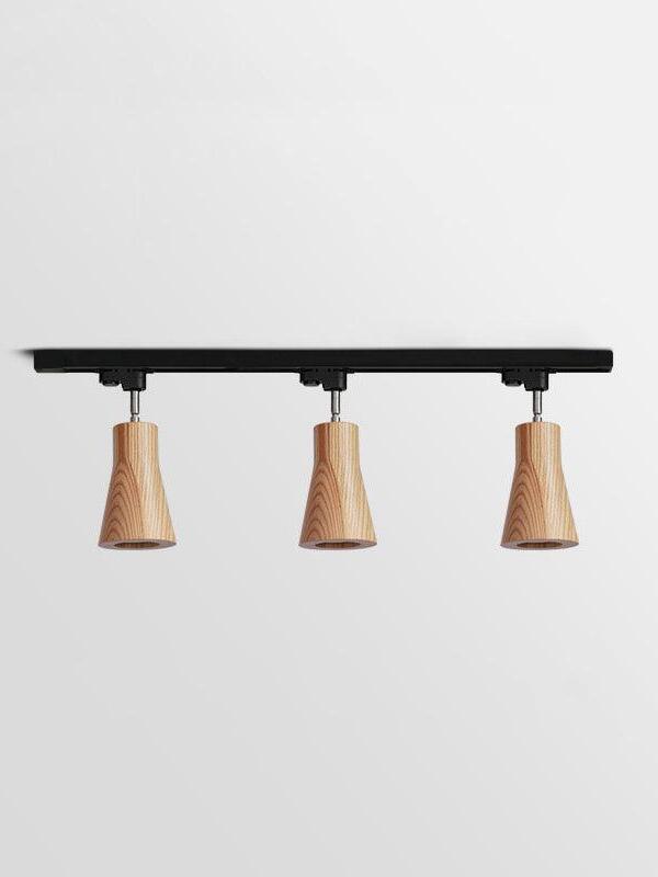 Three pale tapered wooden spots on black bar