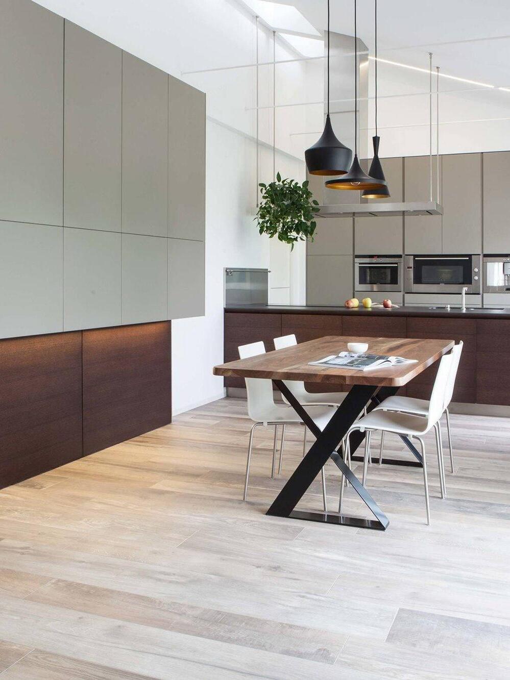 Black pendants above a wood dining table