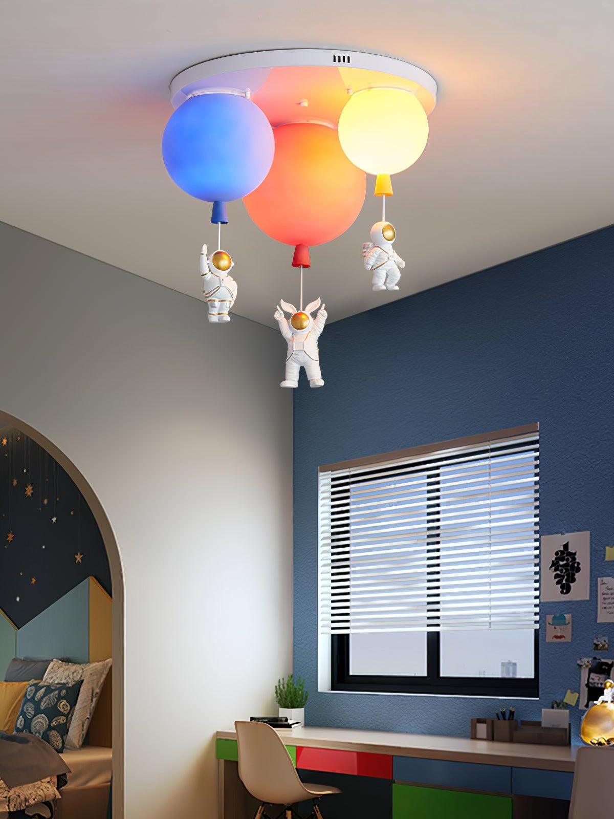 Three-balloon ceiling light in a bedroom with a desk