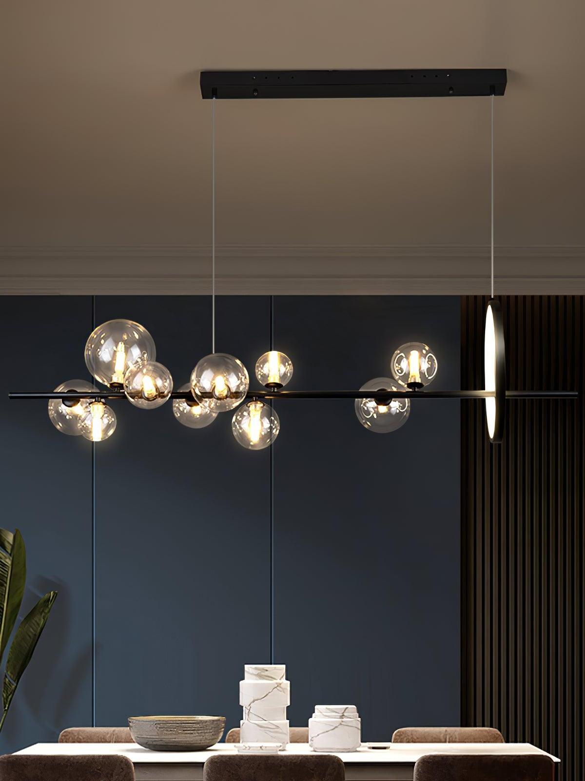 Linear glass chandelier suspended from a black bar canopy