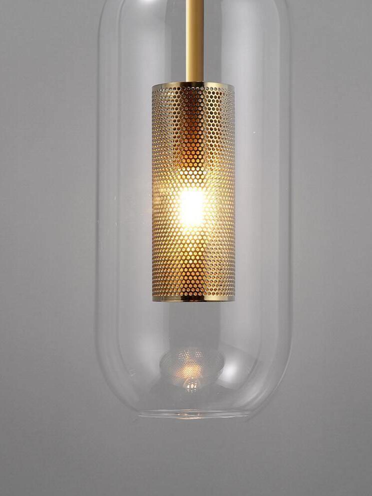 Warm-looking light inside a gold-tone perforated sleeve surrounded by clear capsule glass