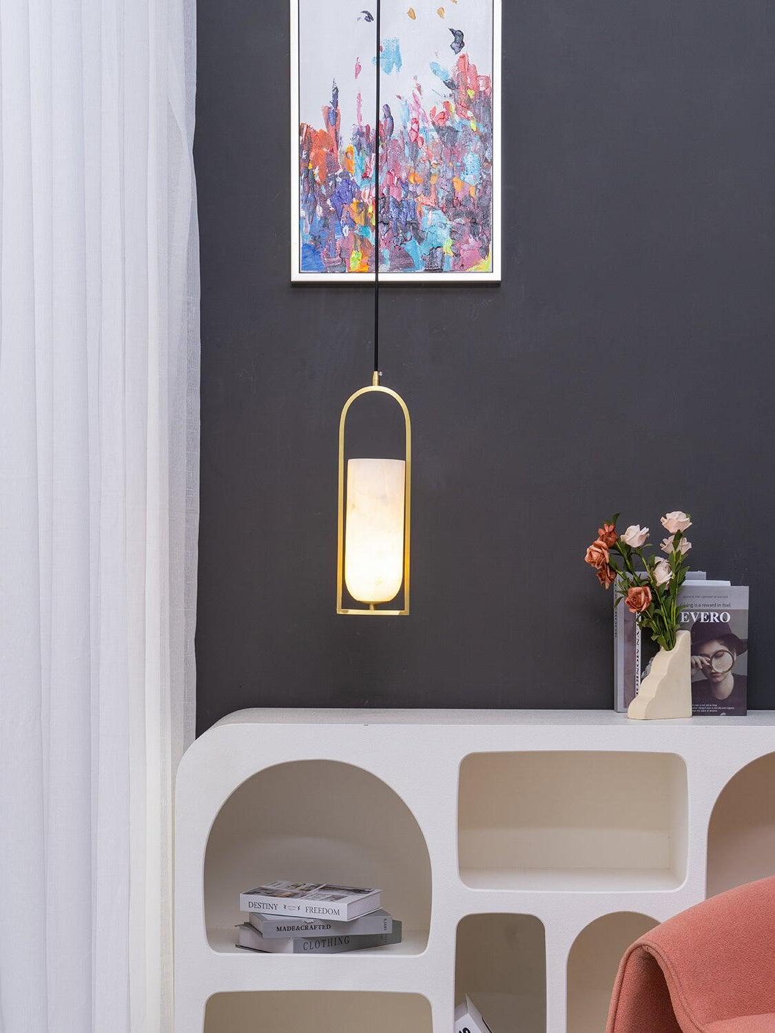 Glowing Melange pendant above a white console near a pink chair and colourful wall art