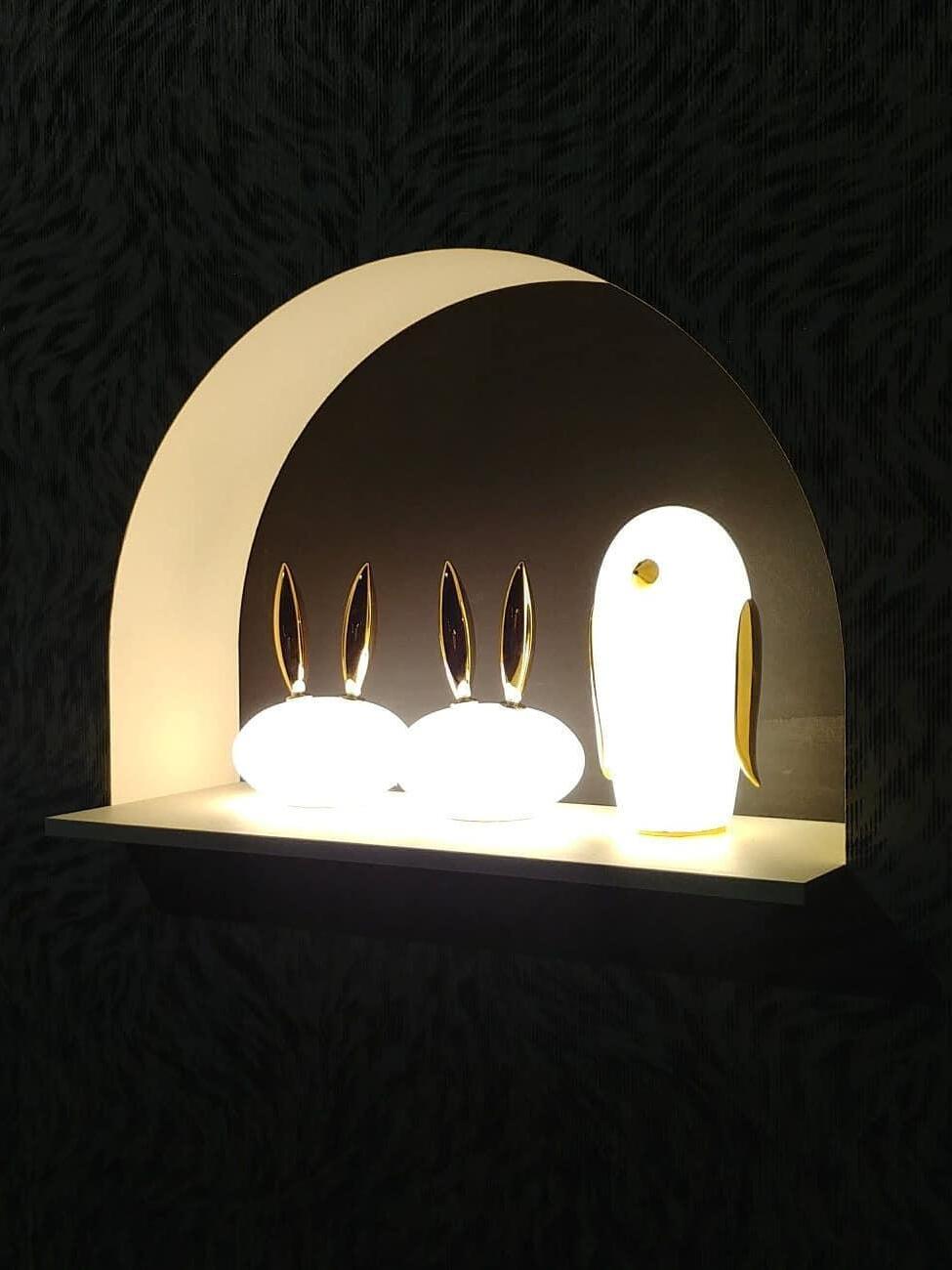Two glowing rabbits and penguin under arch in dark patterned interior