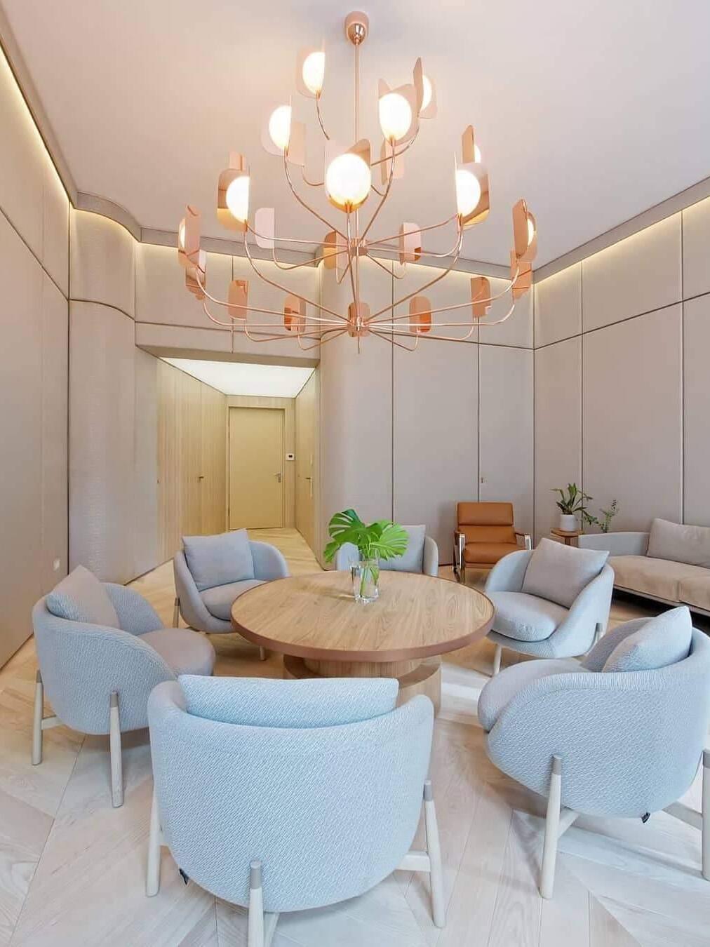 Rose-gold-coloured tiered chandelier over a round table