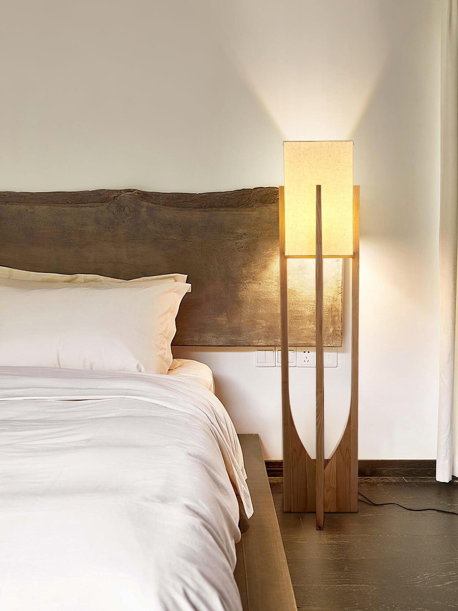 Tall glowing lamp beside bed