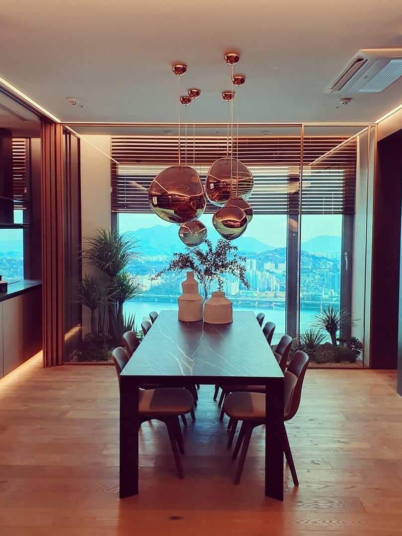 Grouped shades beside a dining room window