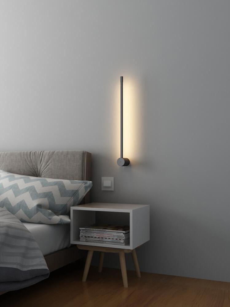 Short vertical light above a bedside cabinet