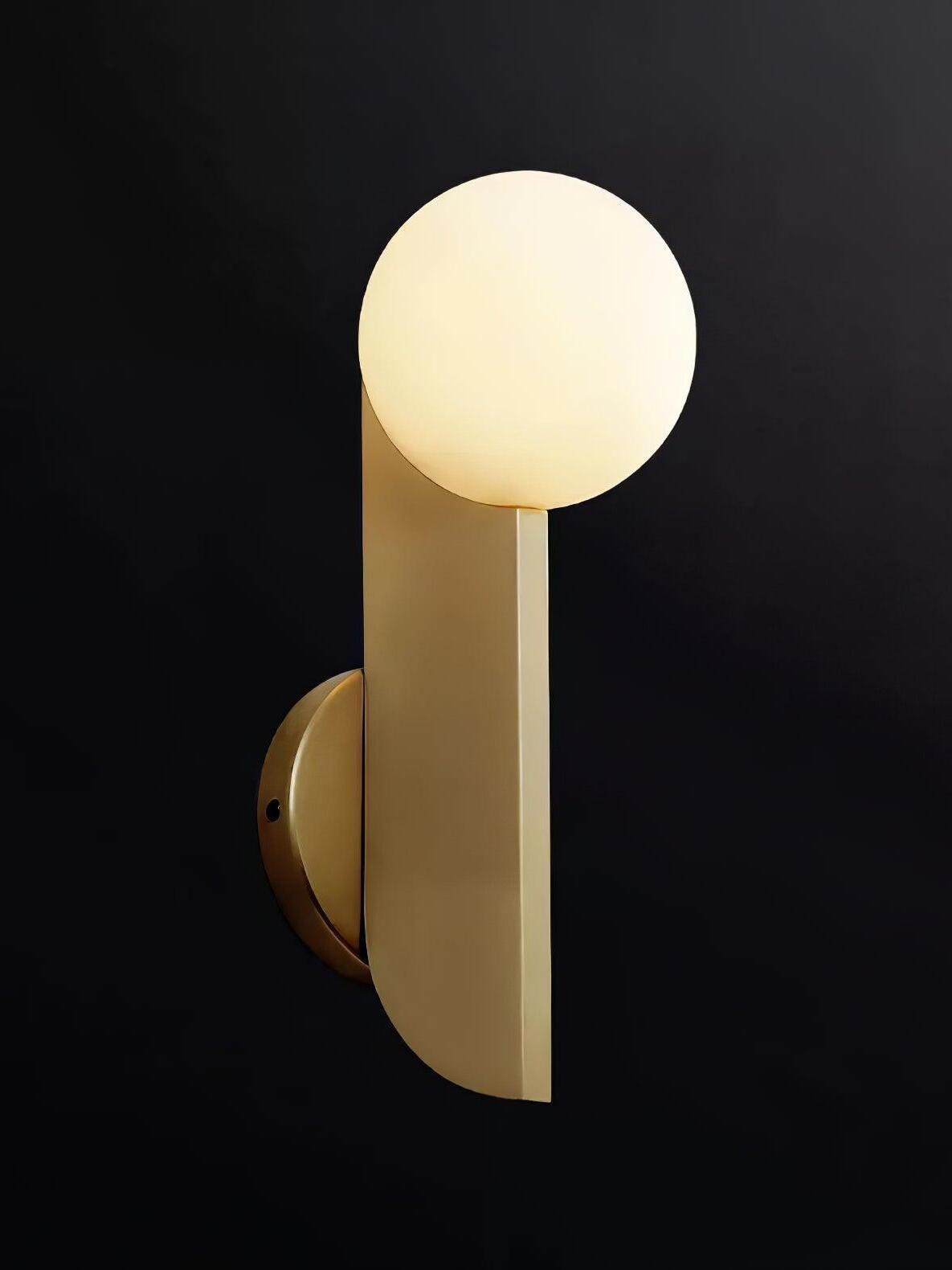 Globe-up wall light with lit white sphere, gold-colour blade and circular plate against black