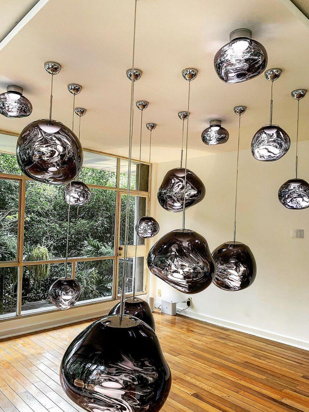 Many dark reflective shades near tall windows