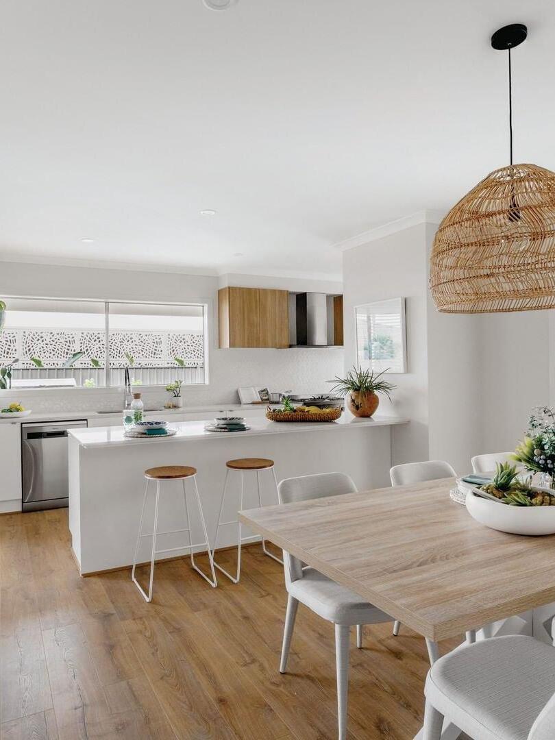 Rattan pendant in a bright dining and kitchen interior
