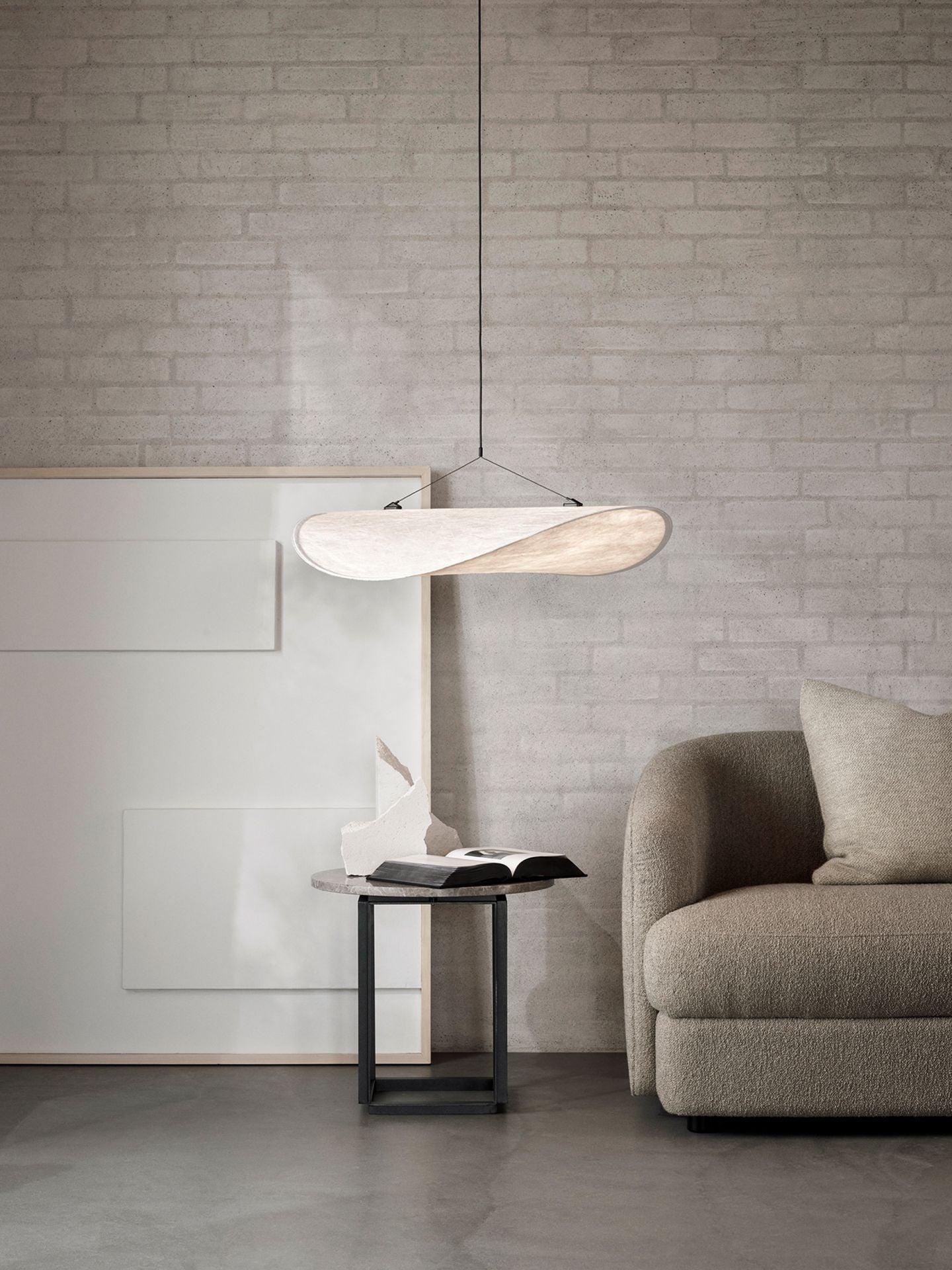 Tense pendant beside a small black table