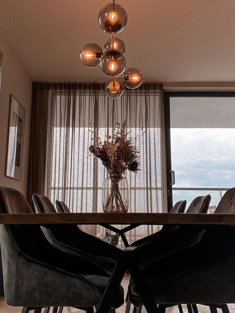 Globe chandelier in a dark dining setting