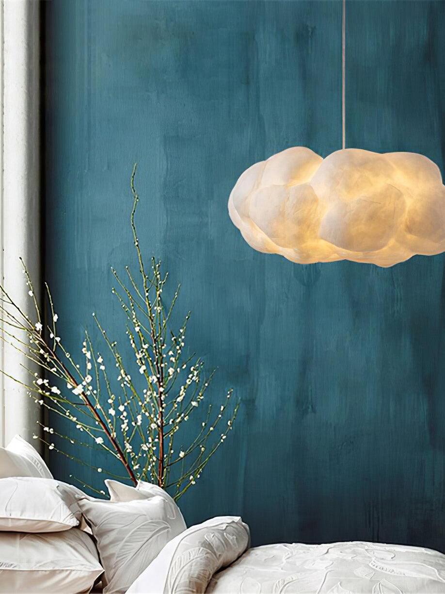 White cloud pendant beside a blue bedroom wall