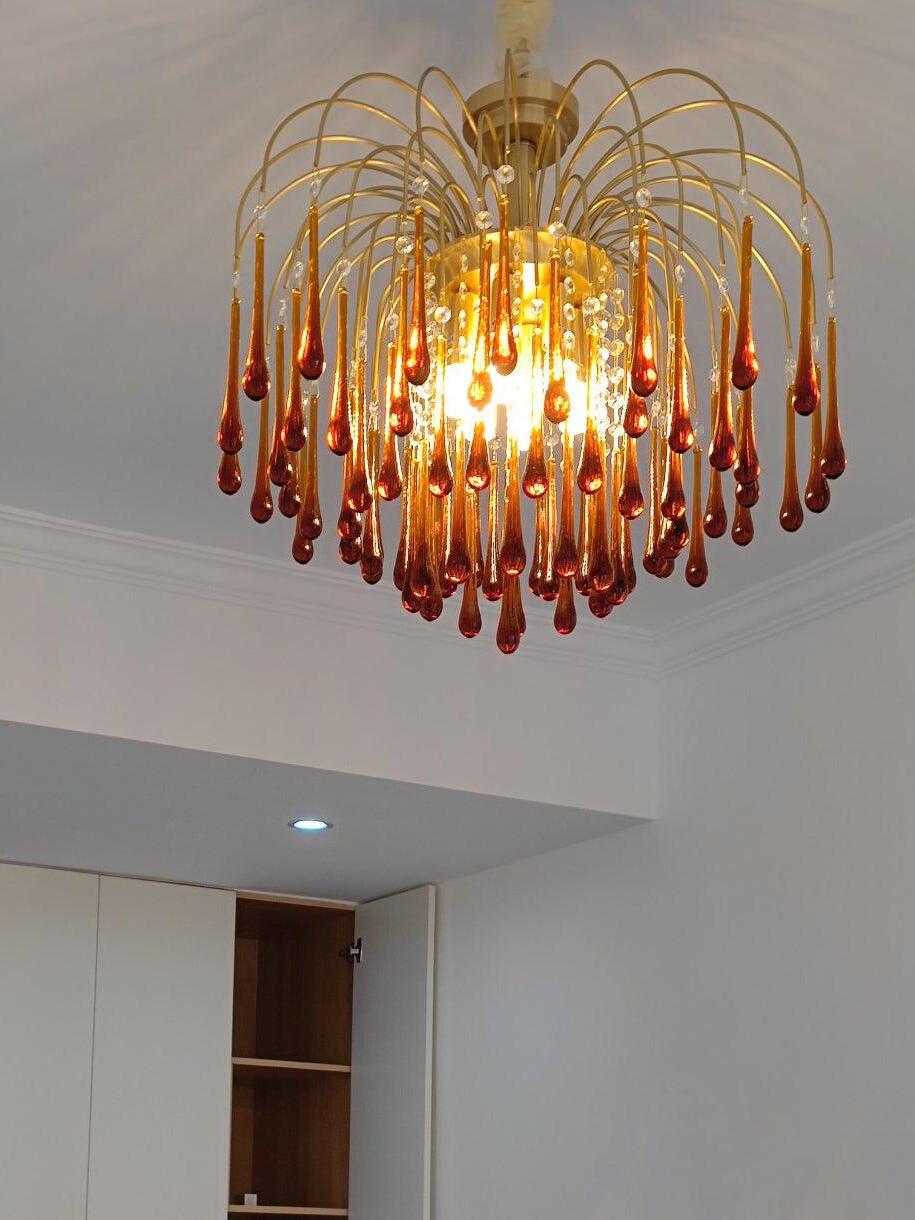 Glowing amber chandelier beneath a ceiling canopy