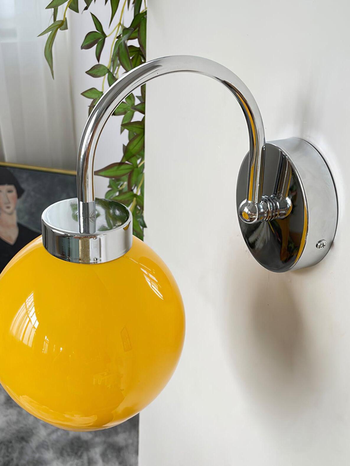 Closer orange globe and polished curved arm with circular wall plate
