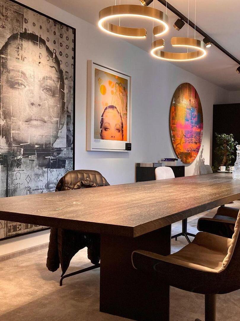 Illuminated rings over a wood dining table