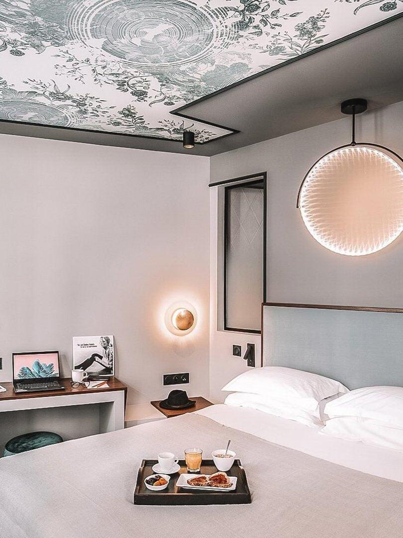 Circular pendant above a bedroom table