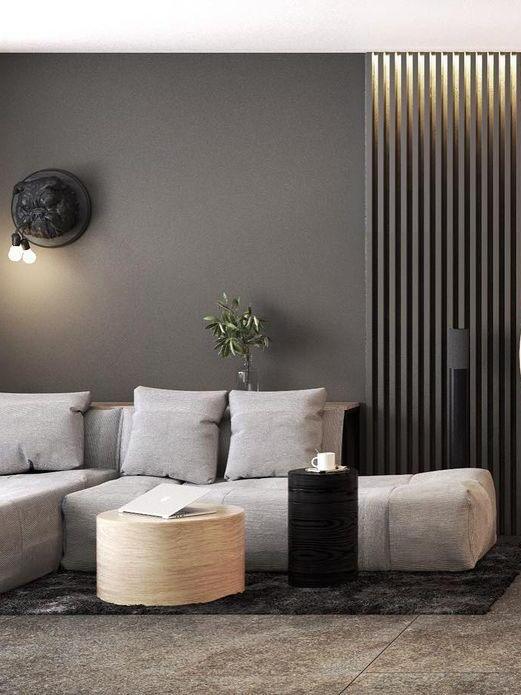 Dark bulldog wall sconce above a sofa and side tables