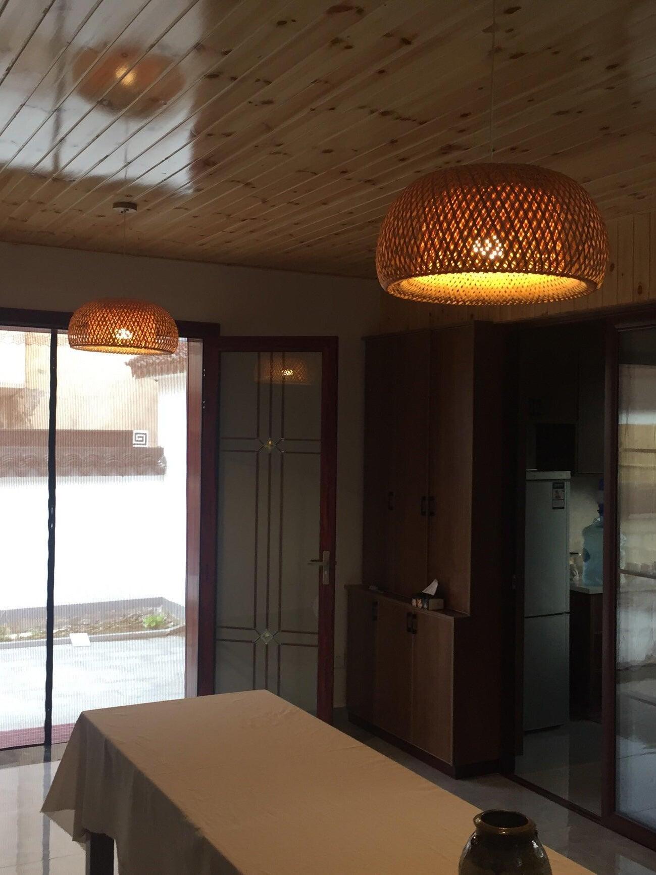 Warm bamboo lattice pendant under timber ceiling