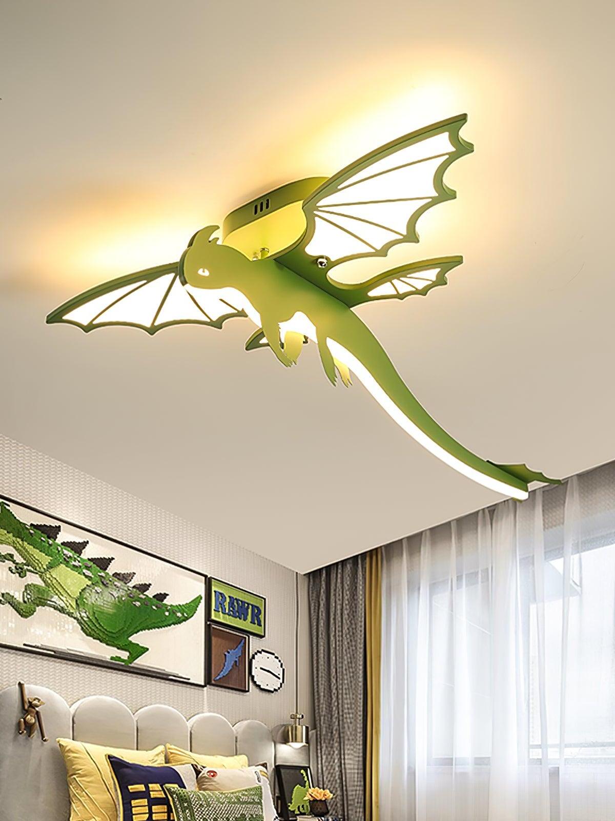 Green winged ceiling light glowing over a bed