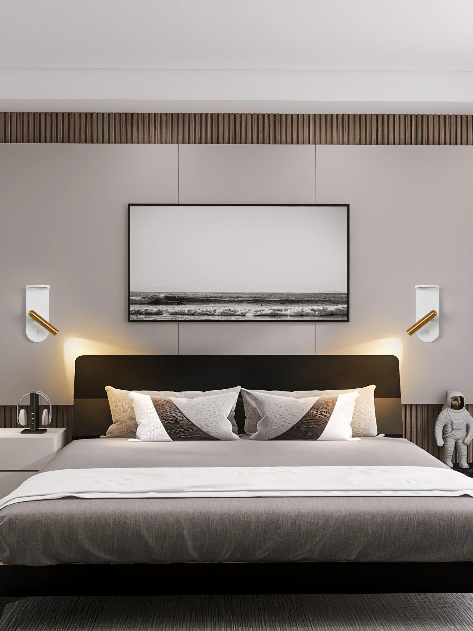 Two white Nights wall lights flanking a bed below a wide framed picture