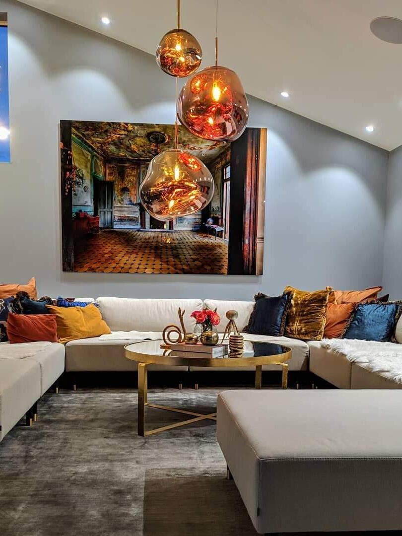 Warm-toned irregular pendants above a living room