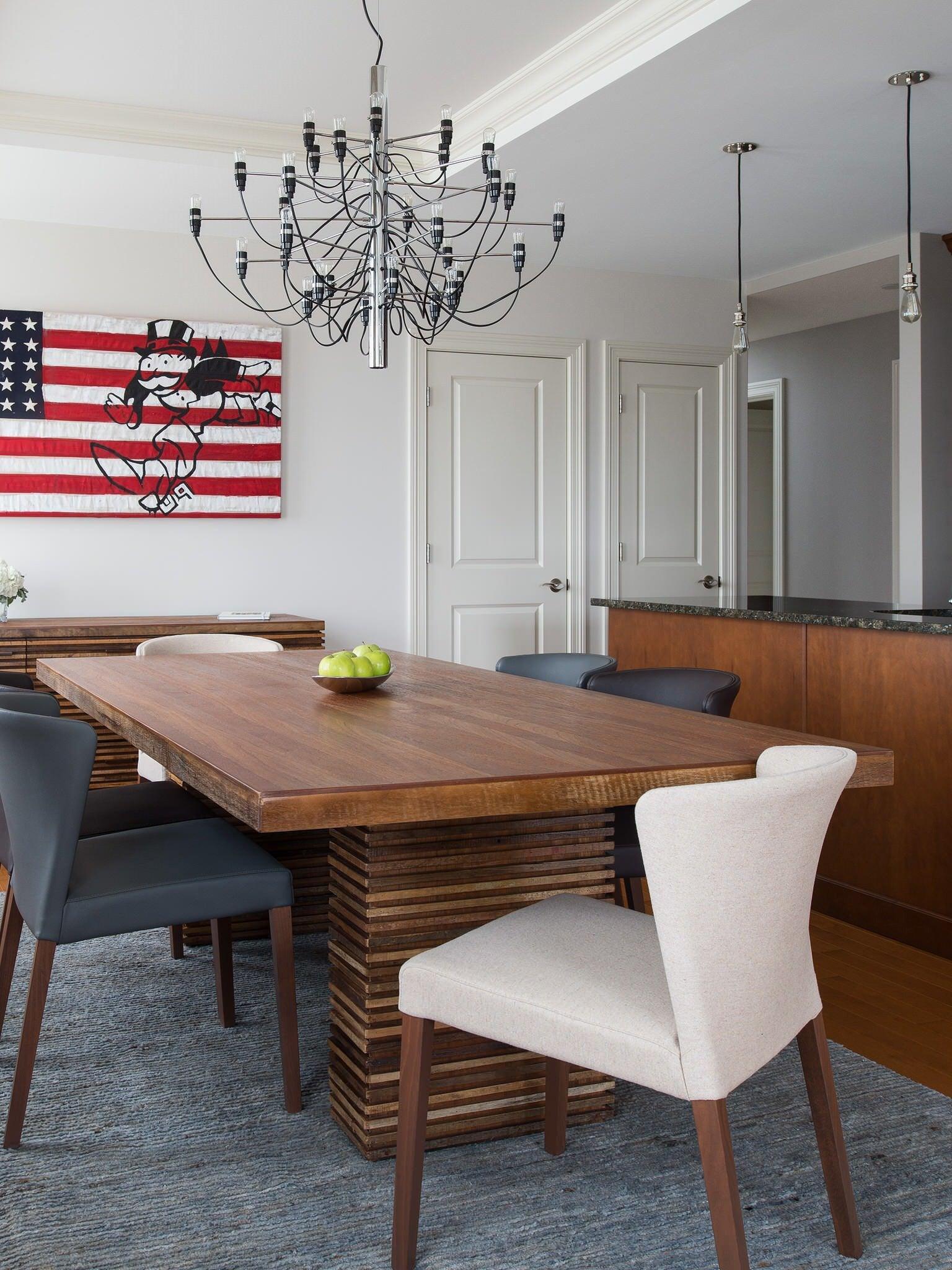 Dark chandelier above a wooden dining table