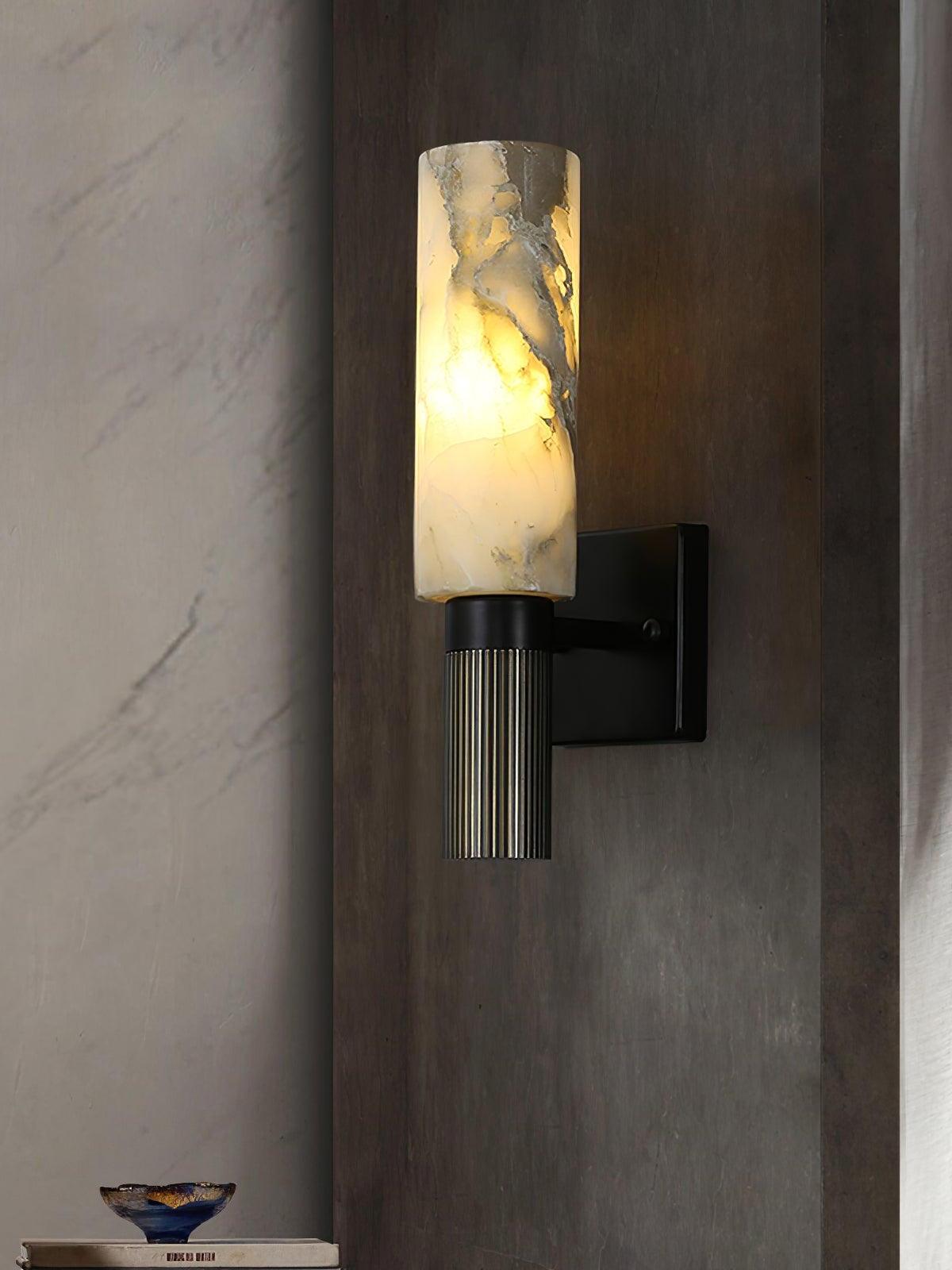Lit marble sconce mounted on dark wood-toned wall