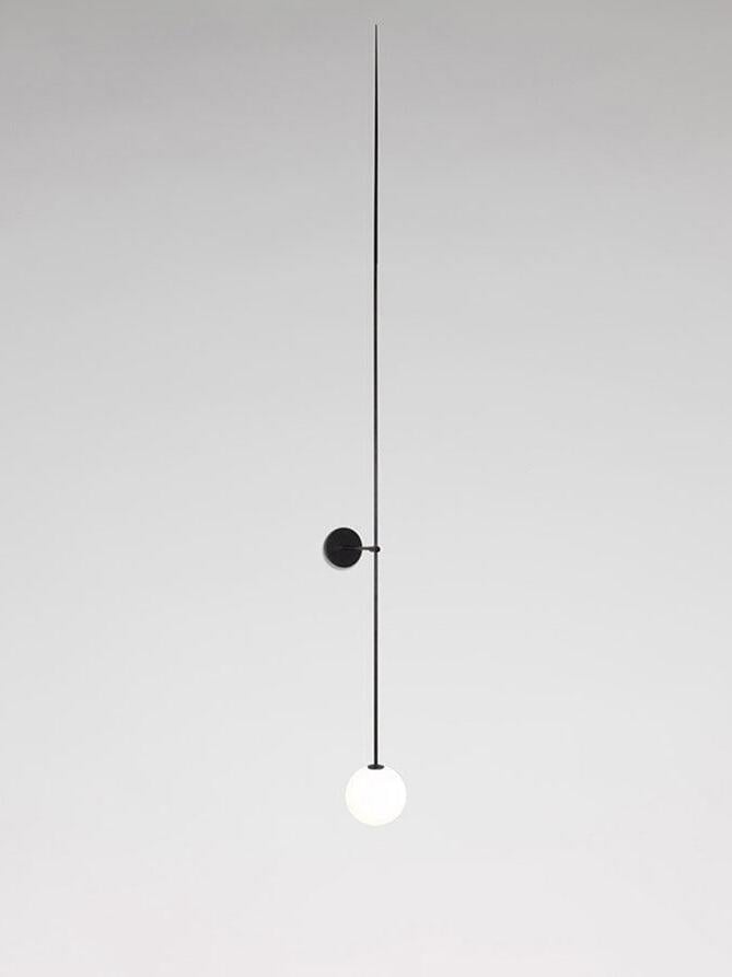 Slightly angled black linear wall light with a glowing globe and long upper rod extension