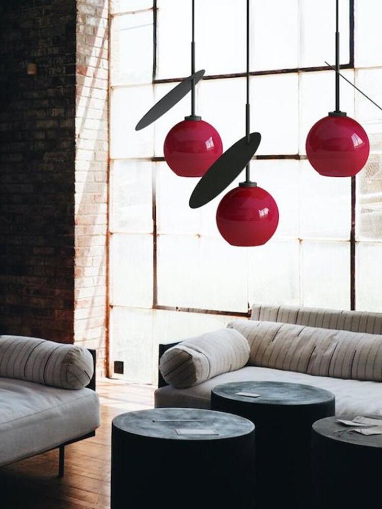 Red Cherry pendants in an indoor seating area