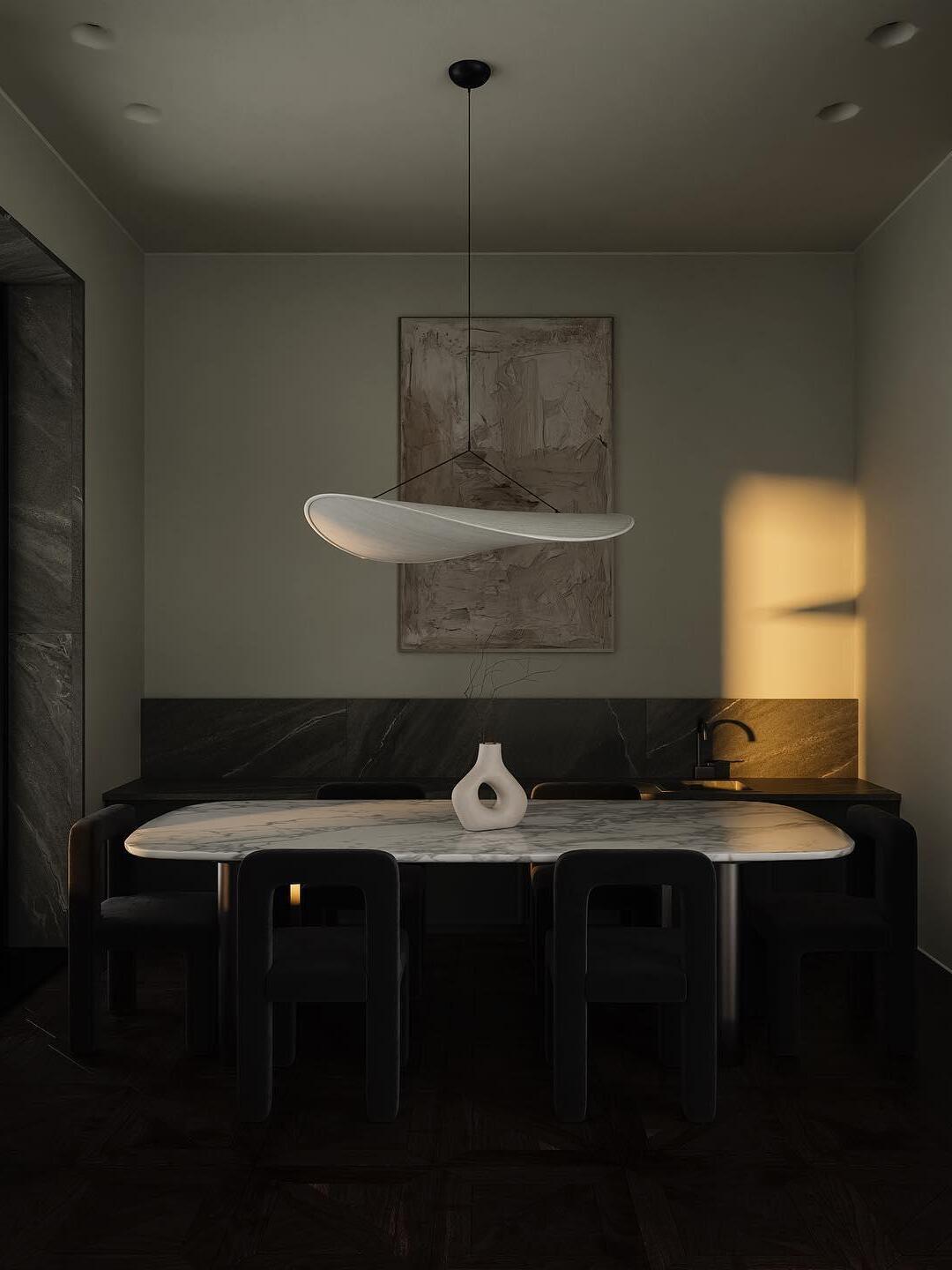 White curved shade in a dark dining corner