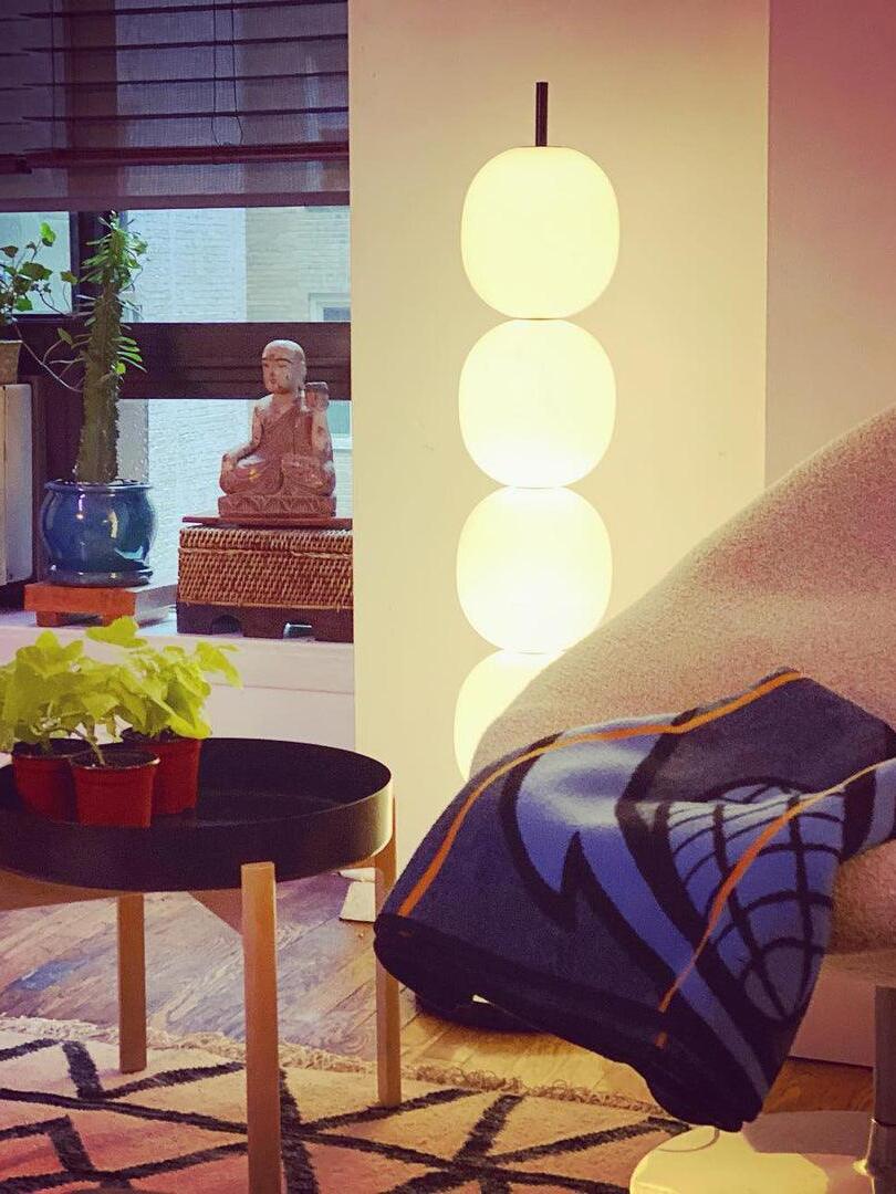 Glowing globe column beside blue chair