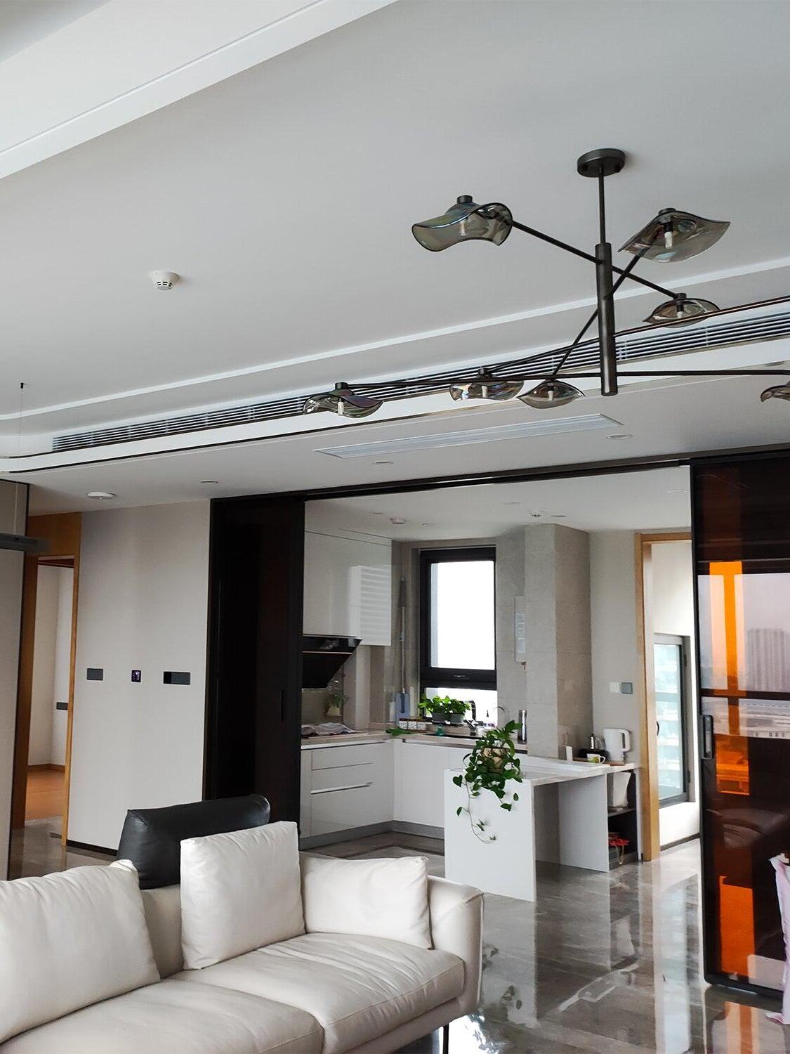 Black glass chandelier in an open-plan living room