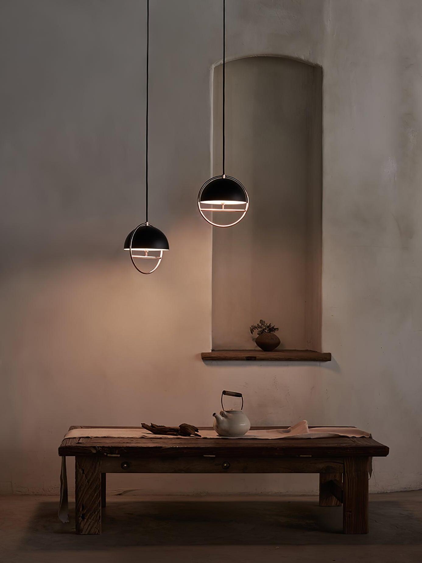 Two black ring pendants above low table