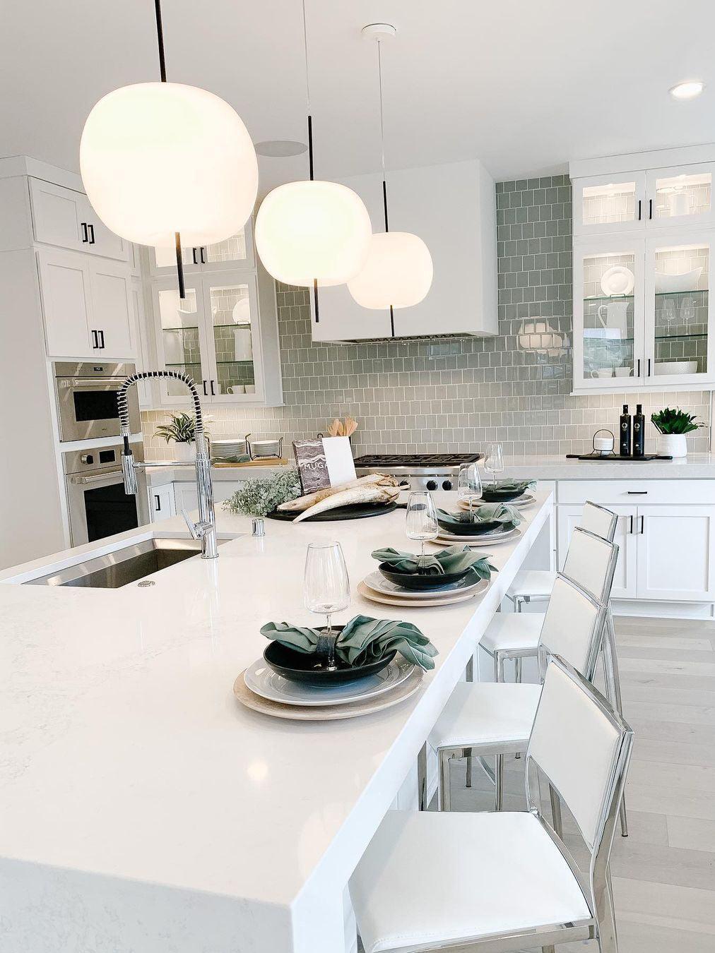 White glass pendants over a table set for dining