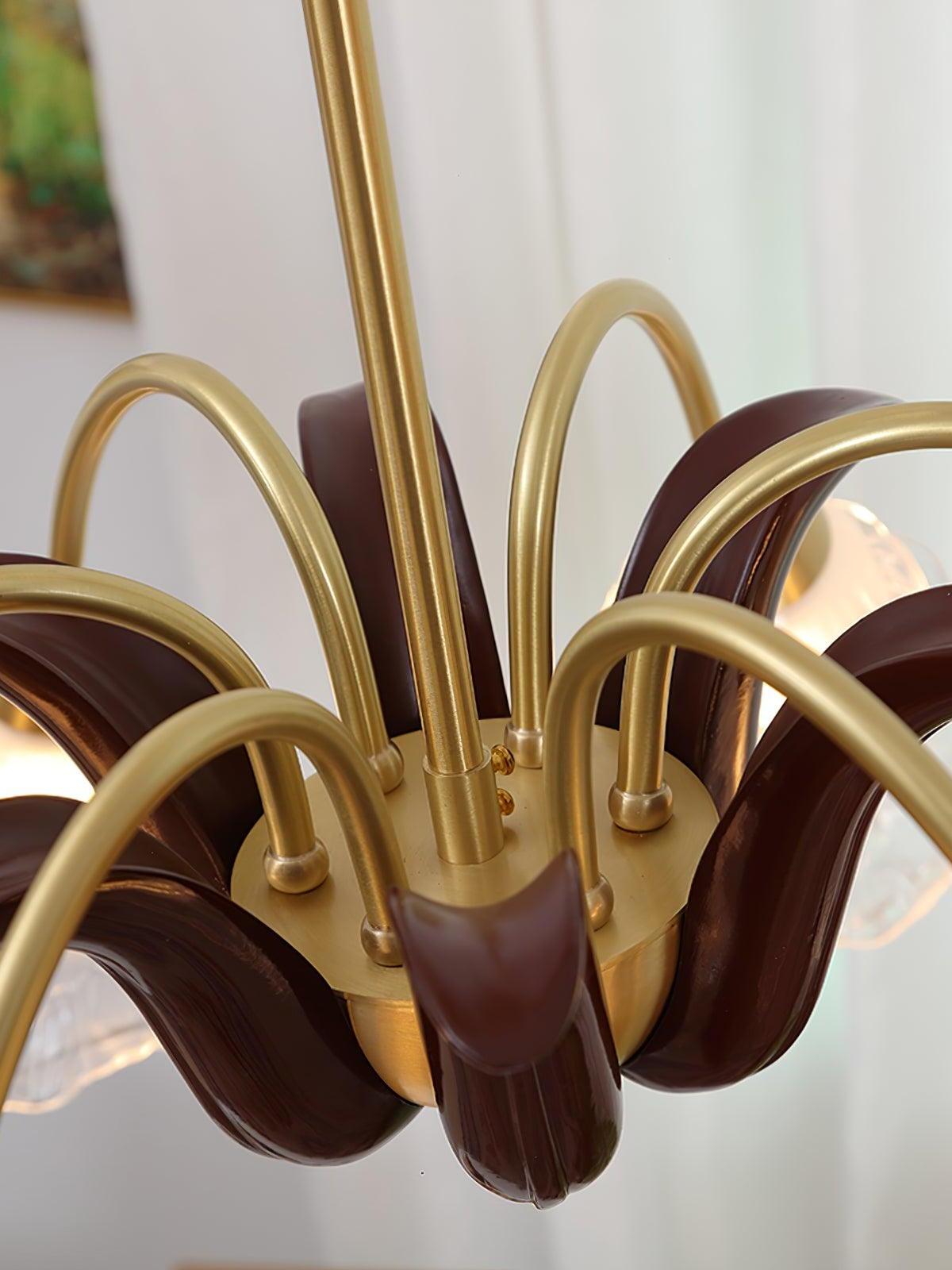 Close burgundy leaf-like centre and brass curved arms