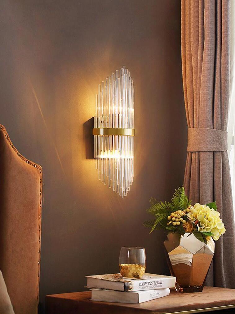 Lit crystal wall light beside curtain and console table