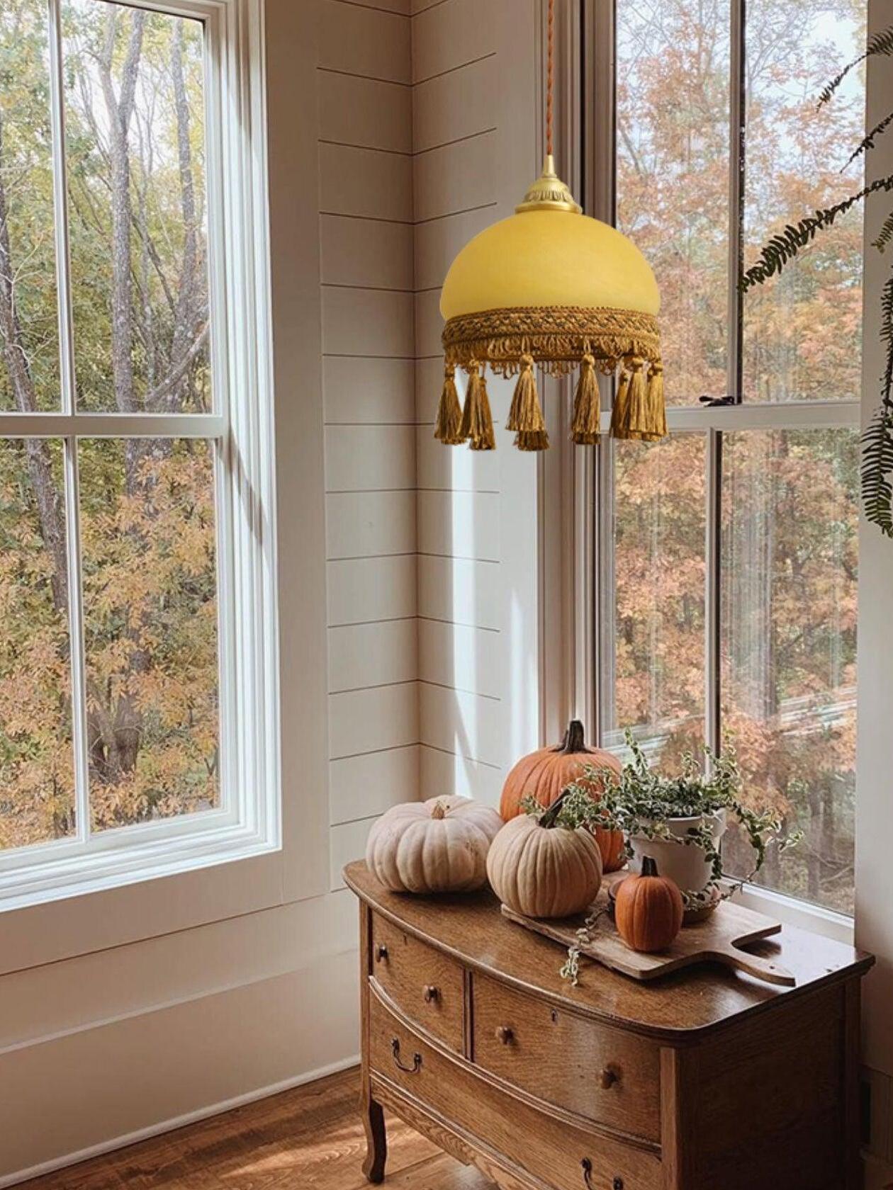 Pendant by window above wood dresser