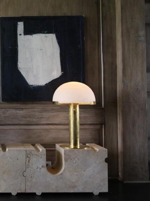 Small dome table lamp on a stone console