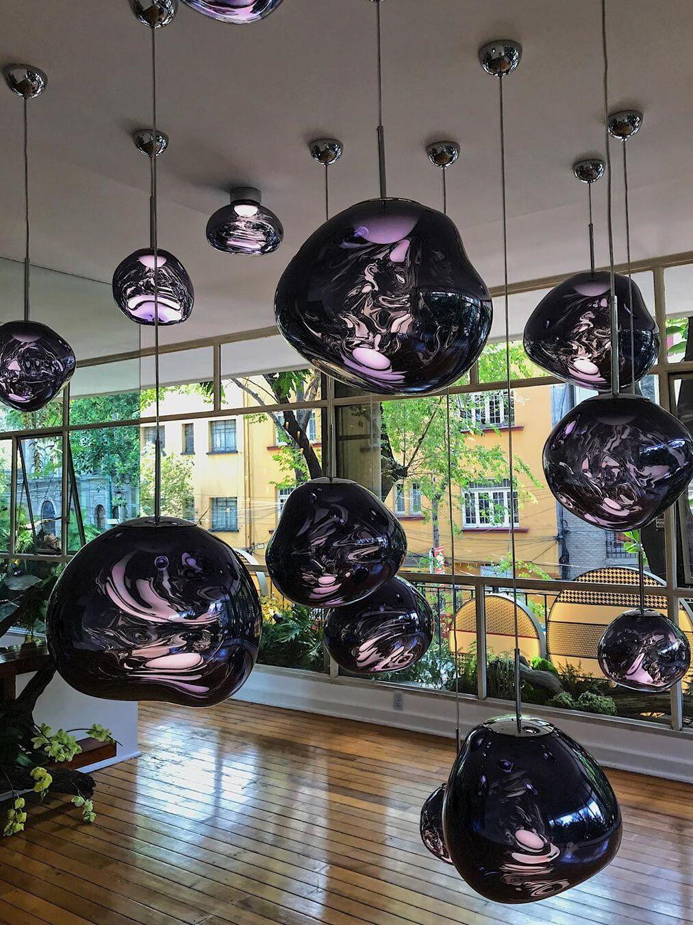 Grouped dark shades in a bright glazed room