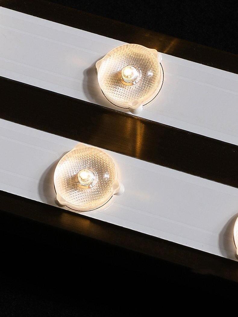 Round scalloped ceiling lights across black and white beams