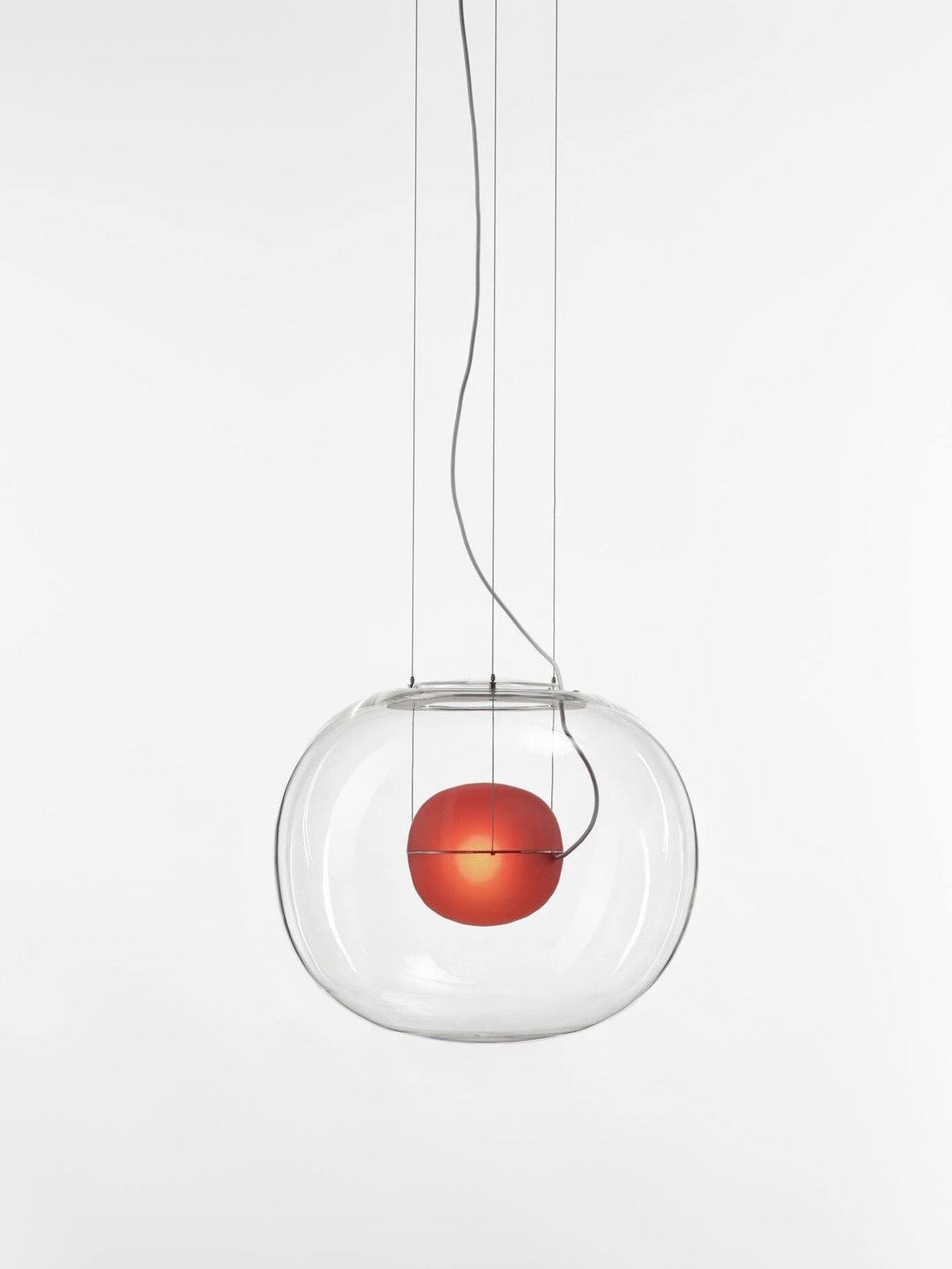 Illuminated red inner sphere suspended within a clear rounded glass shade