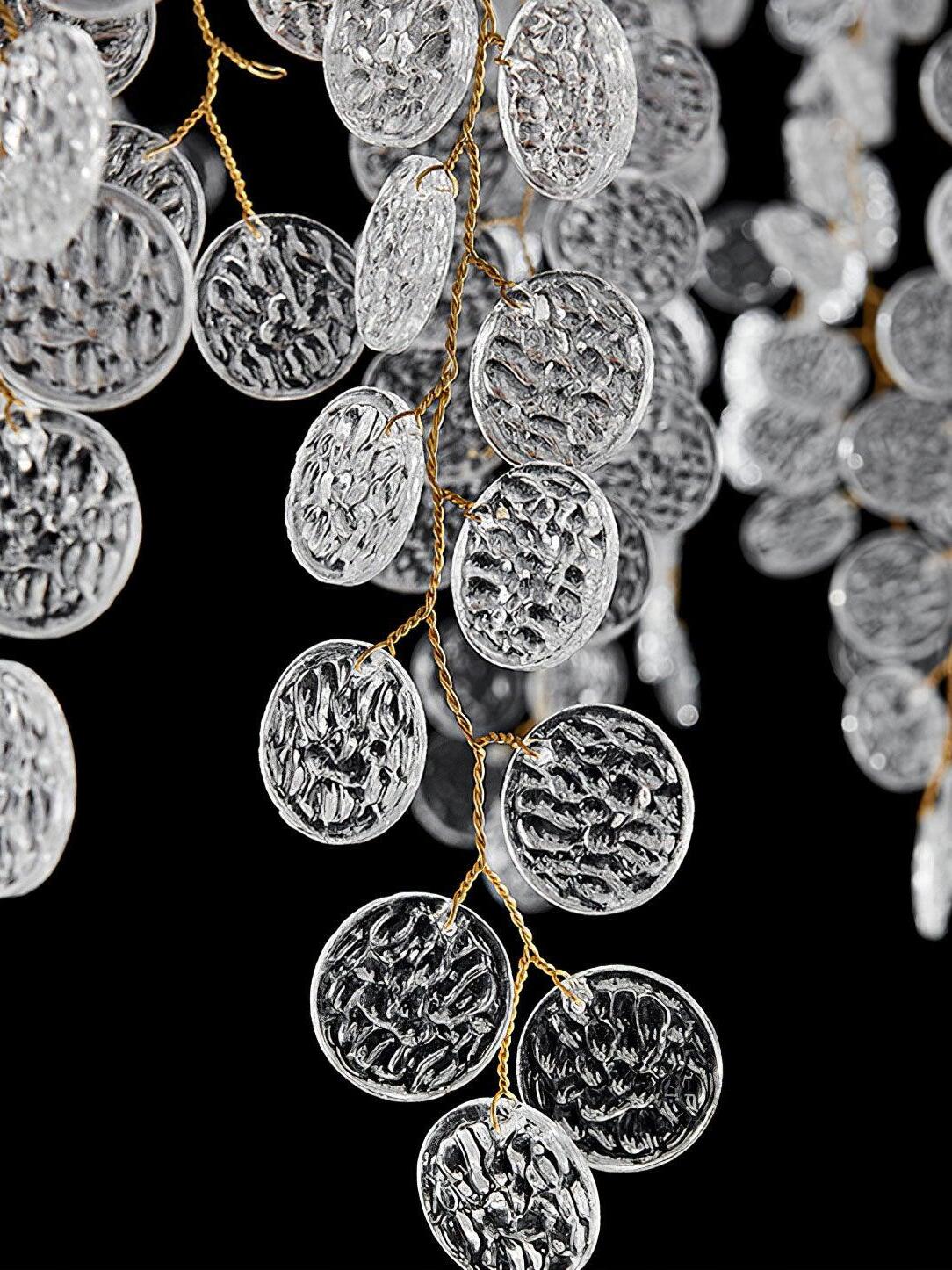 Clear textured discs hanging on gold-toned wire strands